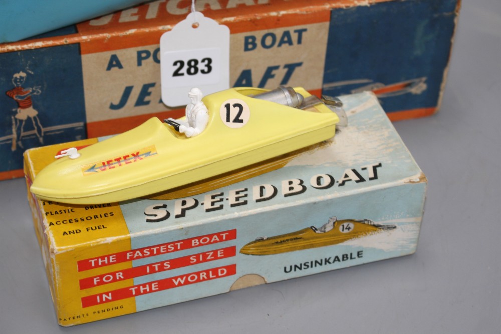 A boxed Jetex plastic fuel propelled model boat, a Jetcraft tinplate burner propelled model power boat and a boxed Mechanex pressed foi